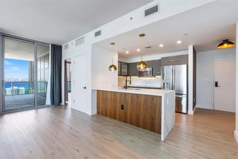 a kitchen with stainless steel appliances granite countertop a refrigerator and a sink