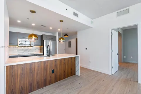 a kitchen with stainless steel appliances a refrigerator and a stove top oven
