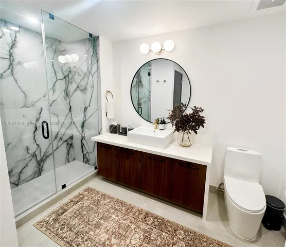 a bathroom with a sink toilet and shower