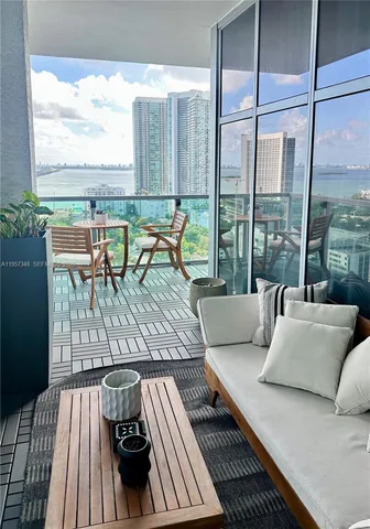 a living room with furniture and large windows