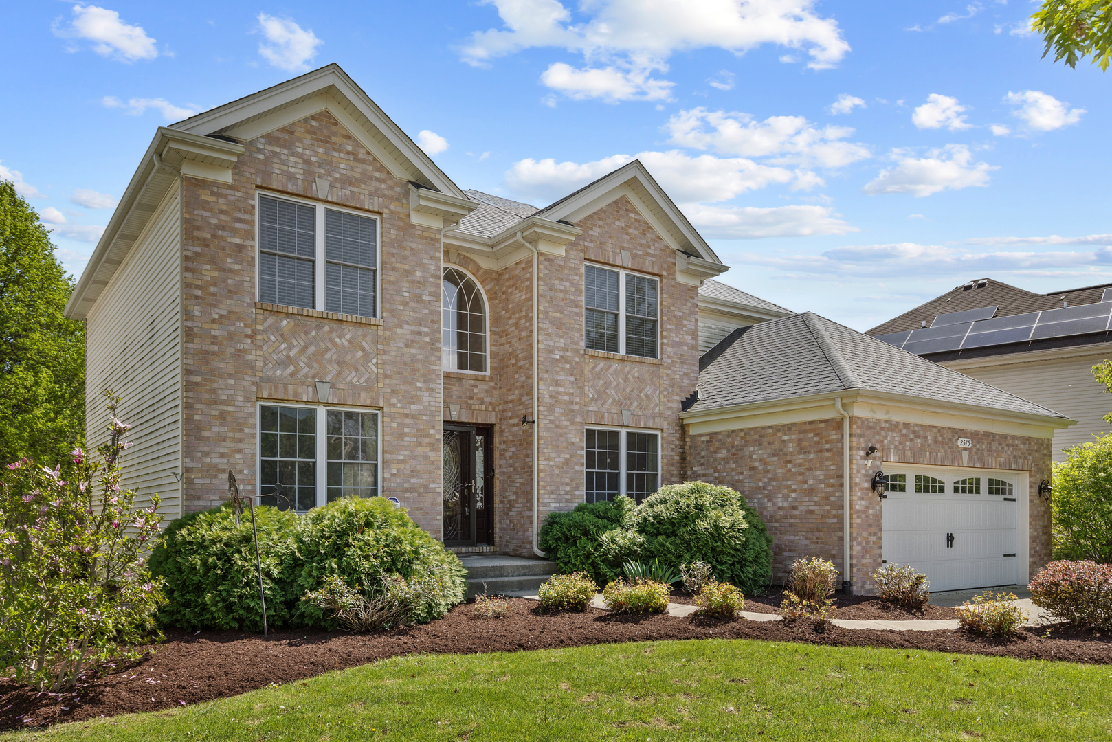 front view of a house with a yard