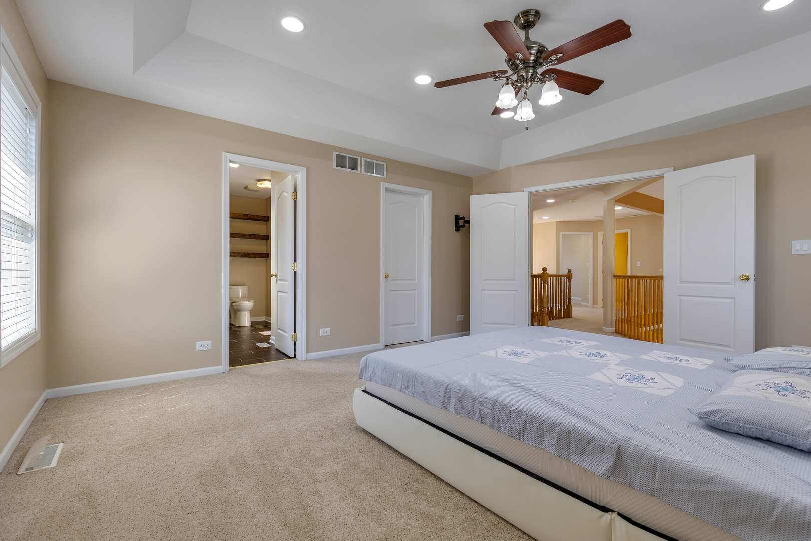 2575 Adamsway Drive Aurora, IL 60502 - Photo 14 of 30 a spacious bedroom with a large bed and a chandelier