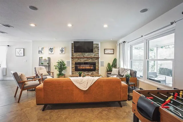 a view of a dining room with furniture a kitchen and chandelier