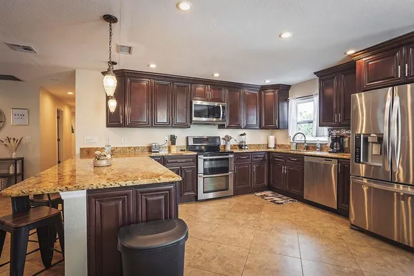 a kitchen with a sink stove and refrigerator