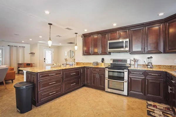a kitchen with a sink stove and microwave