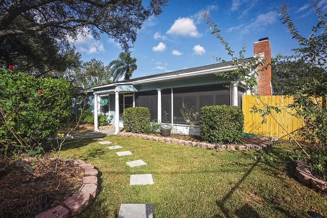 a view of a house with backyard and sitting area