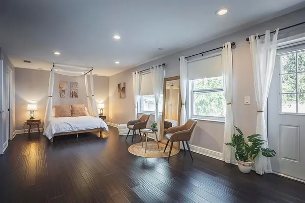 a bedroom with furniture window and wooden floor