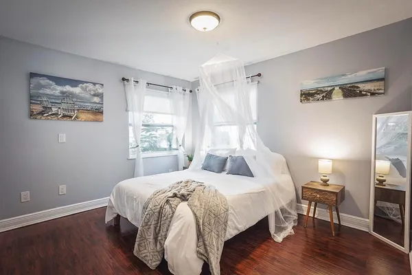 a bedroom with a bed and a window