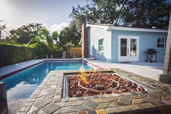 a view of a house with backyard sitting area and garden