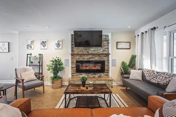 a living room with furniture fireplace and a flat screen tv