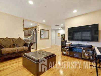 31 Edinburgh Court Edison, NJ 08820 - Photo 6 of 25 a living room with furniture and a flat screen tv