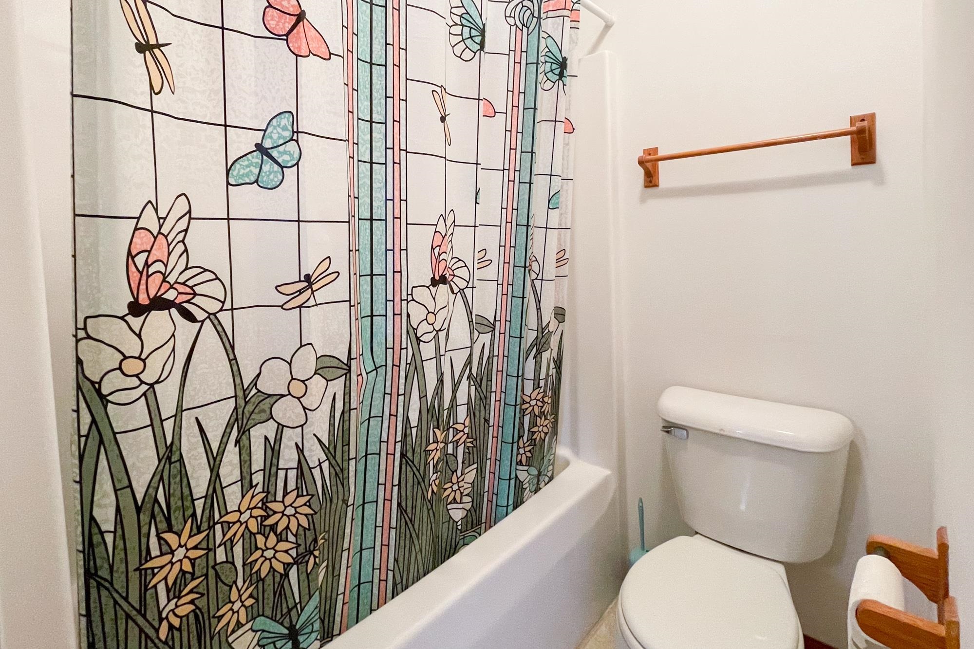 1913 Paddock Court Belvidere, IL 61008 - Photo 12 of 17 a white toilet sitting next to a shower curtain