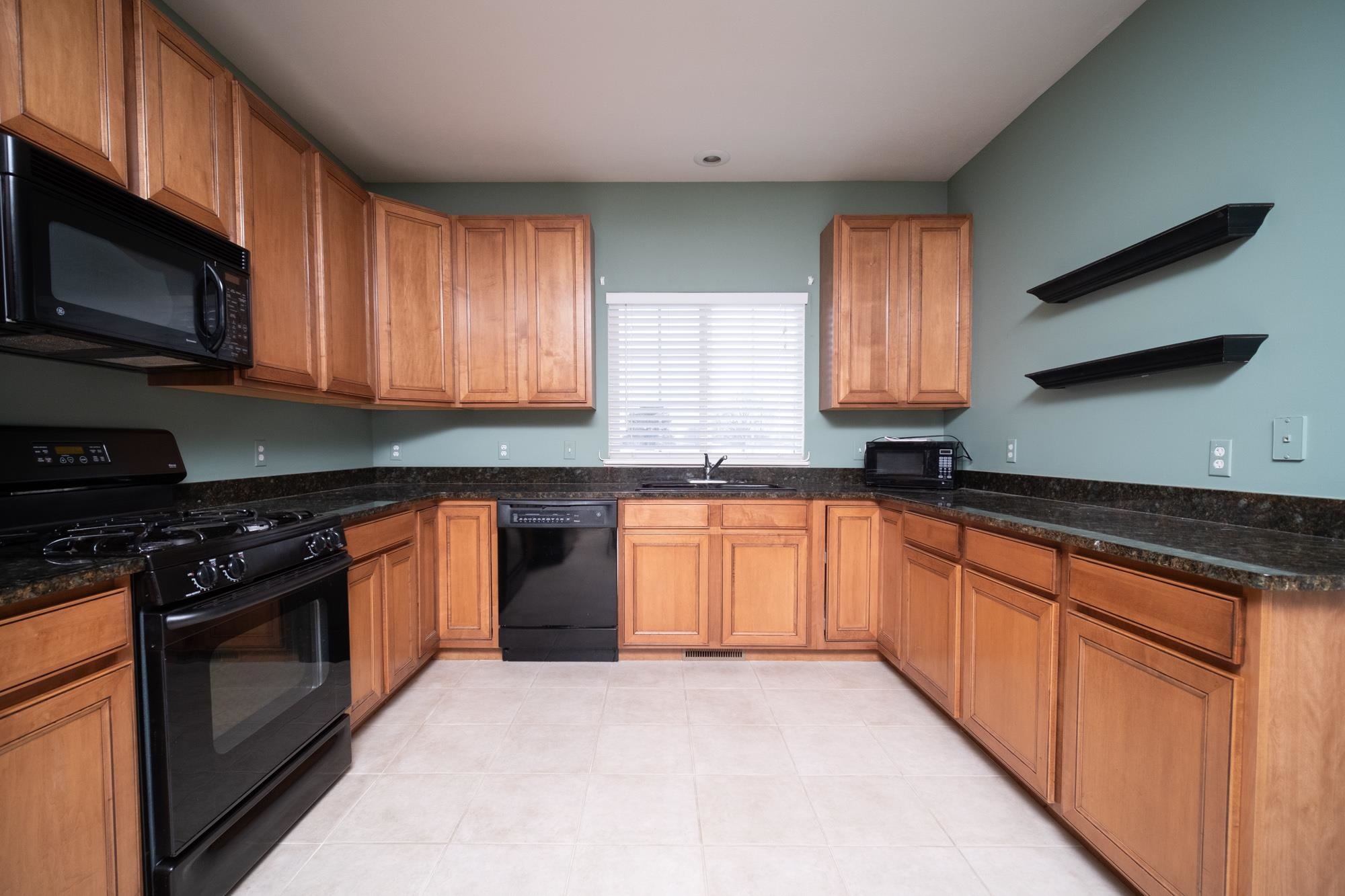 1913 Paddock Court Belvidere, IL 61008 - Photo 3 of 17 a kitchen with stainless steel appliances granite countertop a stove a sink and a microwave