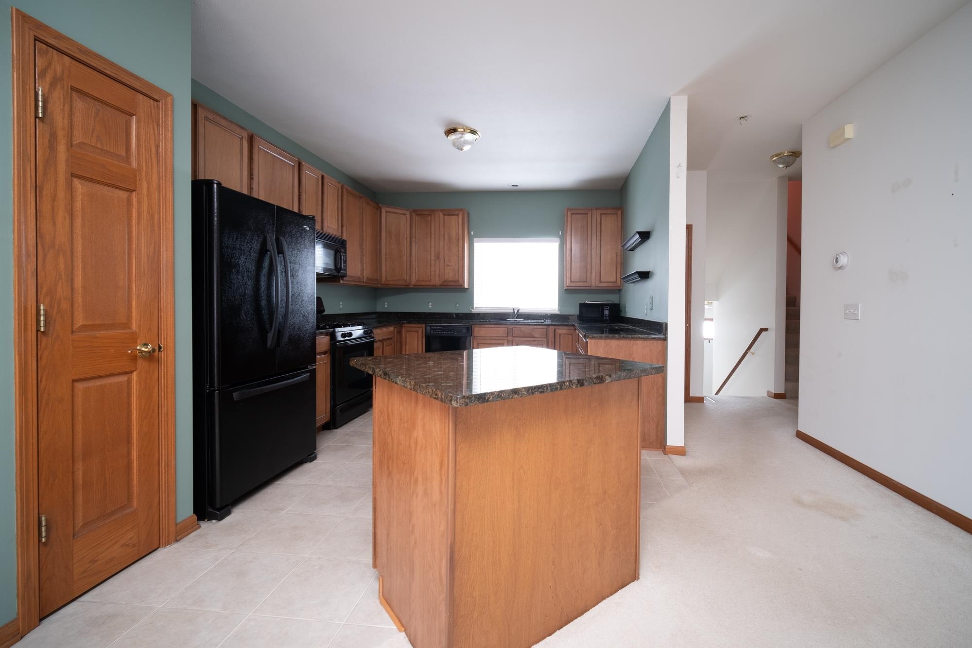 1913 Paddock Court Belvidere, IL 61008 - Photo 4 of 17 a kitchen with stainless steel appliances granite countertop a refrigerator and a stove top oven