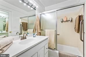 2 Hamlet Hill Road Baltimore, MD 21210 - Photo 16 of 20 a bathroom with a double vanity sink a mirror and a glass door shower