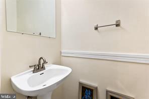 2 Hamlet Hill Road Baltimore, MD 21210 - Photo 10 of 20 a bathroom with a sink and mirror