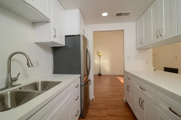 a kitchen with a sink and a refrigerator