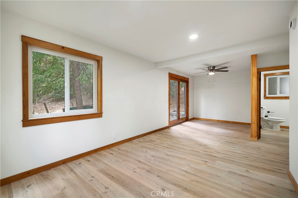 814 Glen View Lane Twin Peaks, CA 92391 - Photo 14 of 38 a view of an empty room with wooden floor and a window