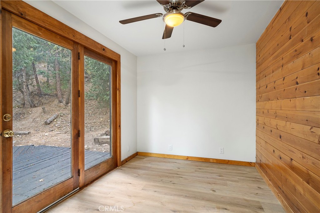 814 Glen View Lane Twin Peaks, CA 92391 - Photo 15 of 38 a view of empty room with wooden floor and fan