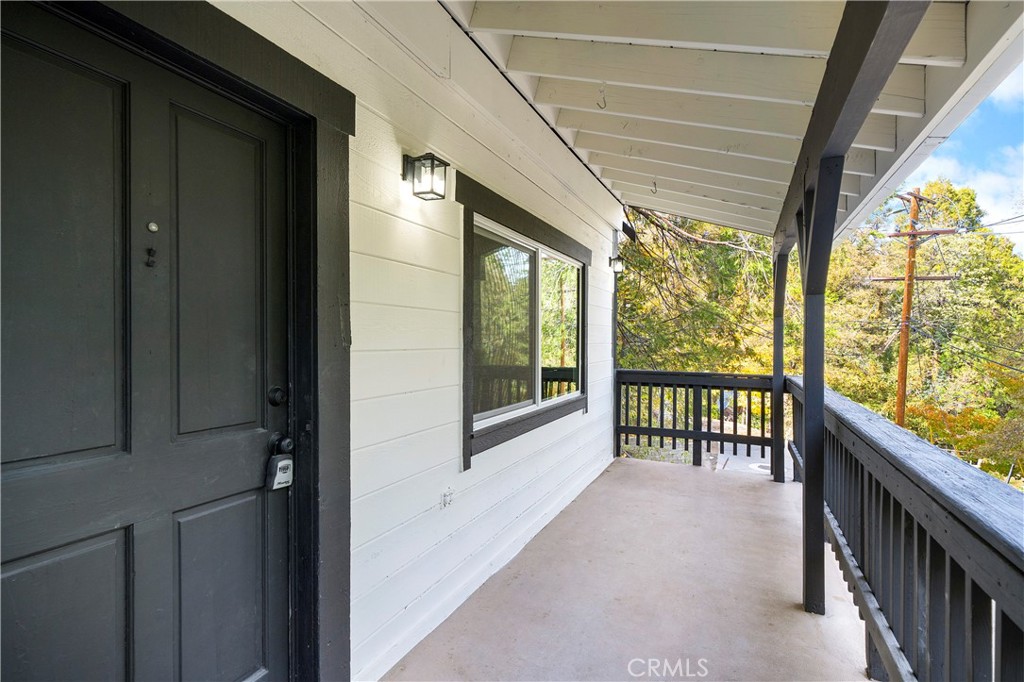 814 Glen View Lane Twin Peaks, CA 92391 - Photo 4 of 38 a view of a porch with wooden floor and floor to ceiling window