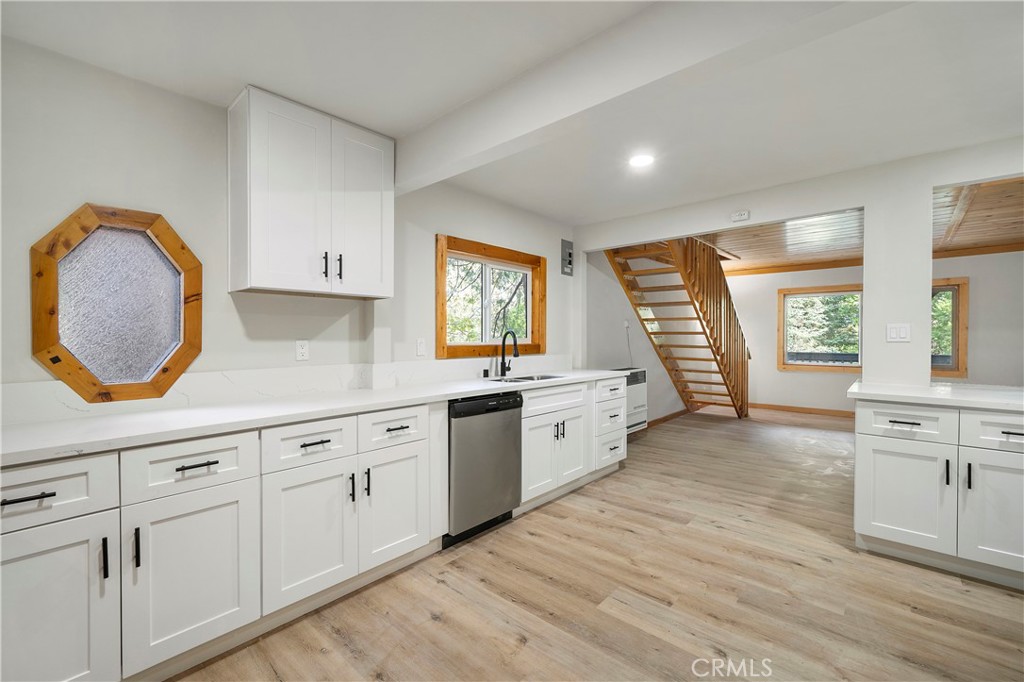 814 Glen View Lane Twin Peaks, CA 92391 - Photo 10 of 38 a large kitchen with granite countertop a stove a sink and a large window
