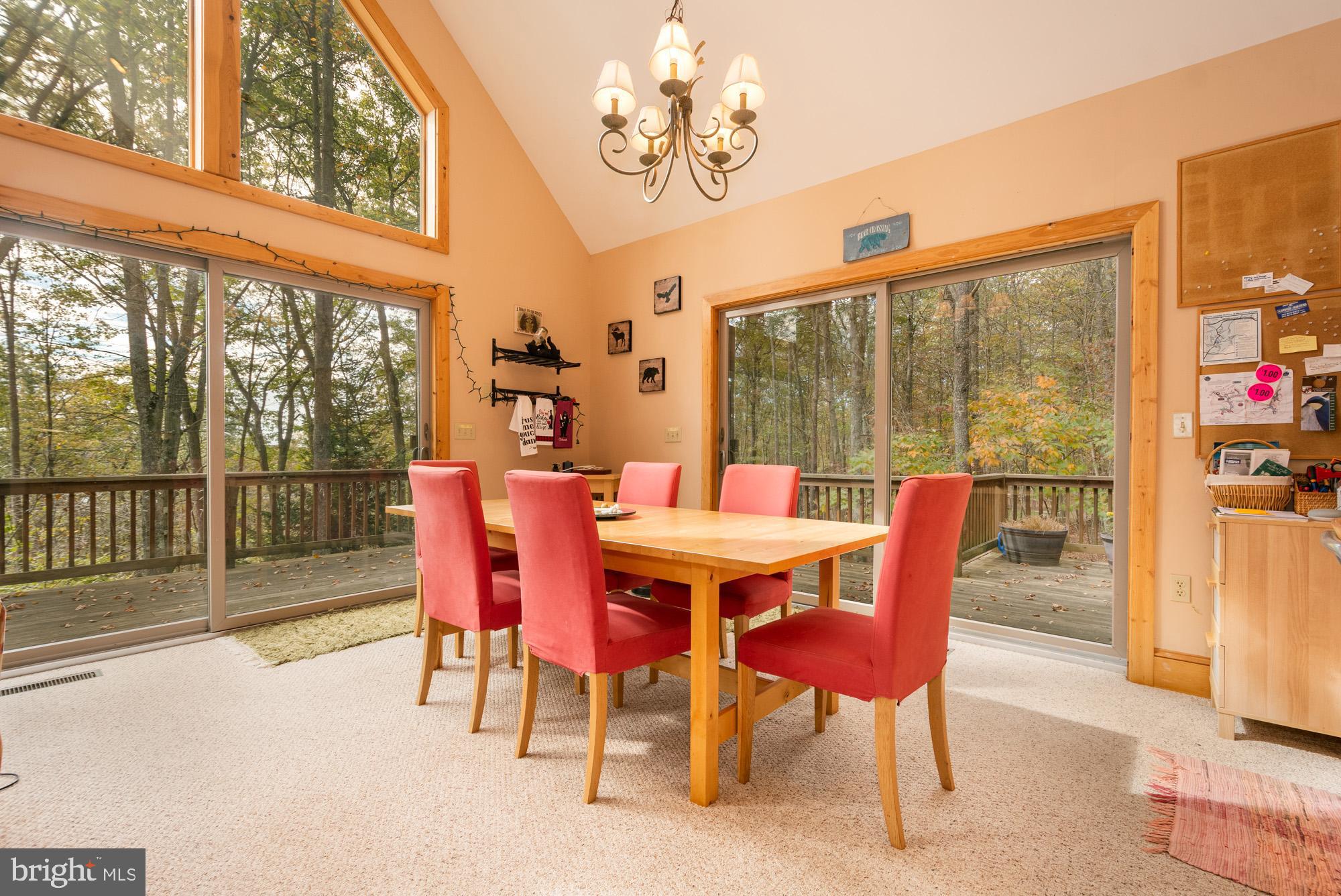 31 Linz Lane Swanton, MD 21561 - Photo 17 of 51 a view of a dining room with furniture a chandelier and a large window