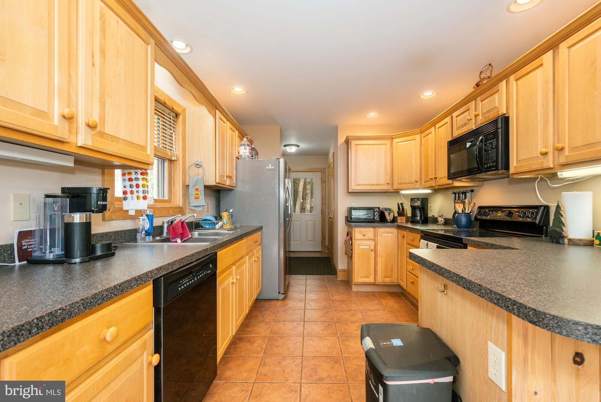31 Linz Lane Swanton, MD 21561 - Photo 19 of 51 a kitchen with stainless steel appliances granite countertop a stove a sink and a microwave