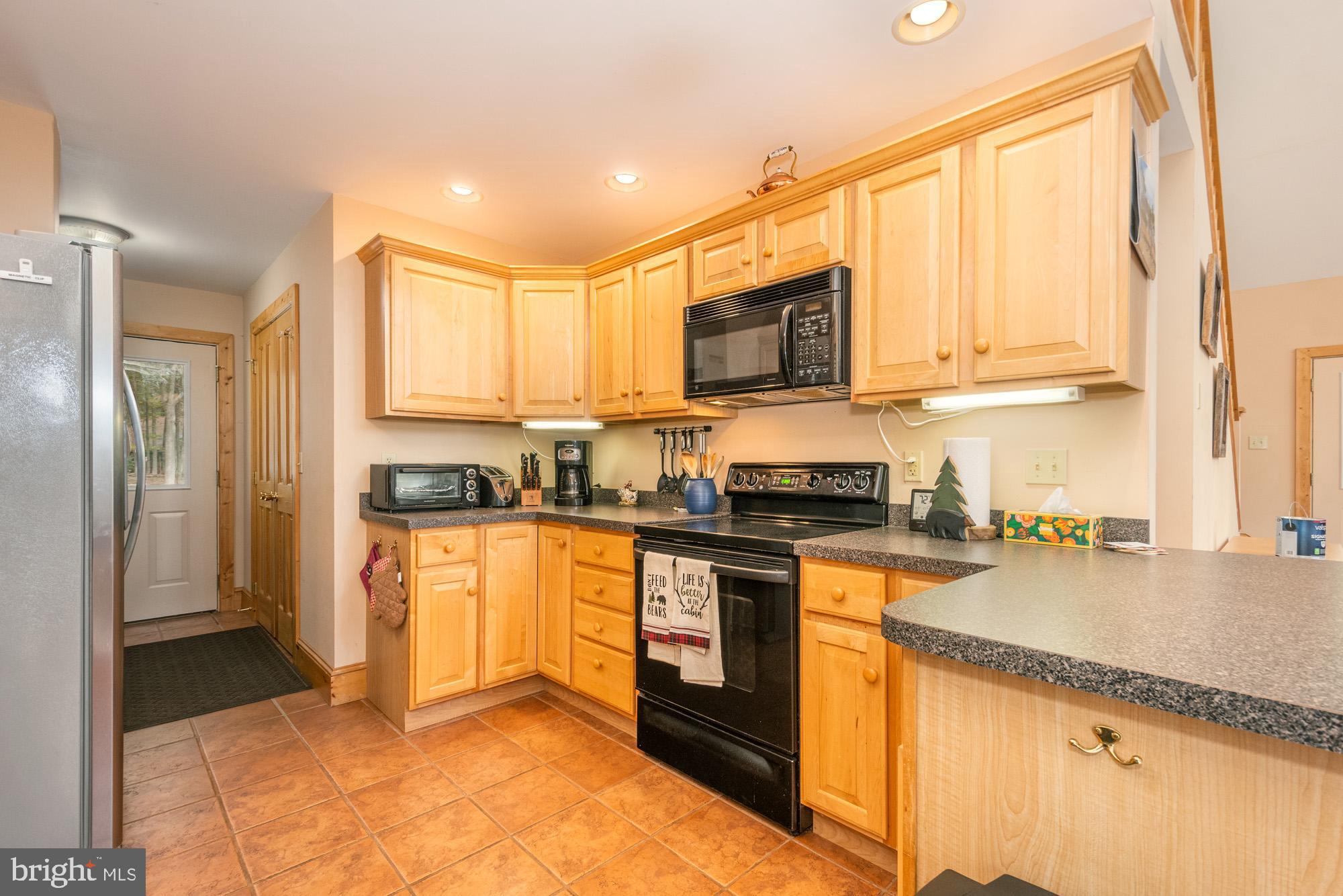 31 Linz Lane Swanton, MD 21561 - Photo 20 of 51 a kitchen with stainless steel appliances granite countertop a stove a sink and a microwave