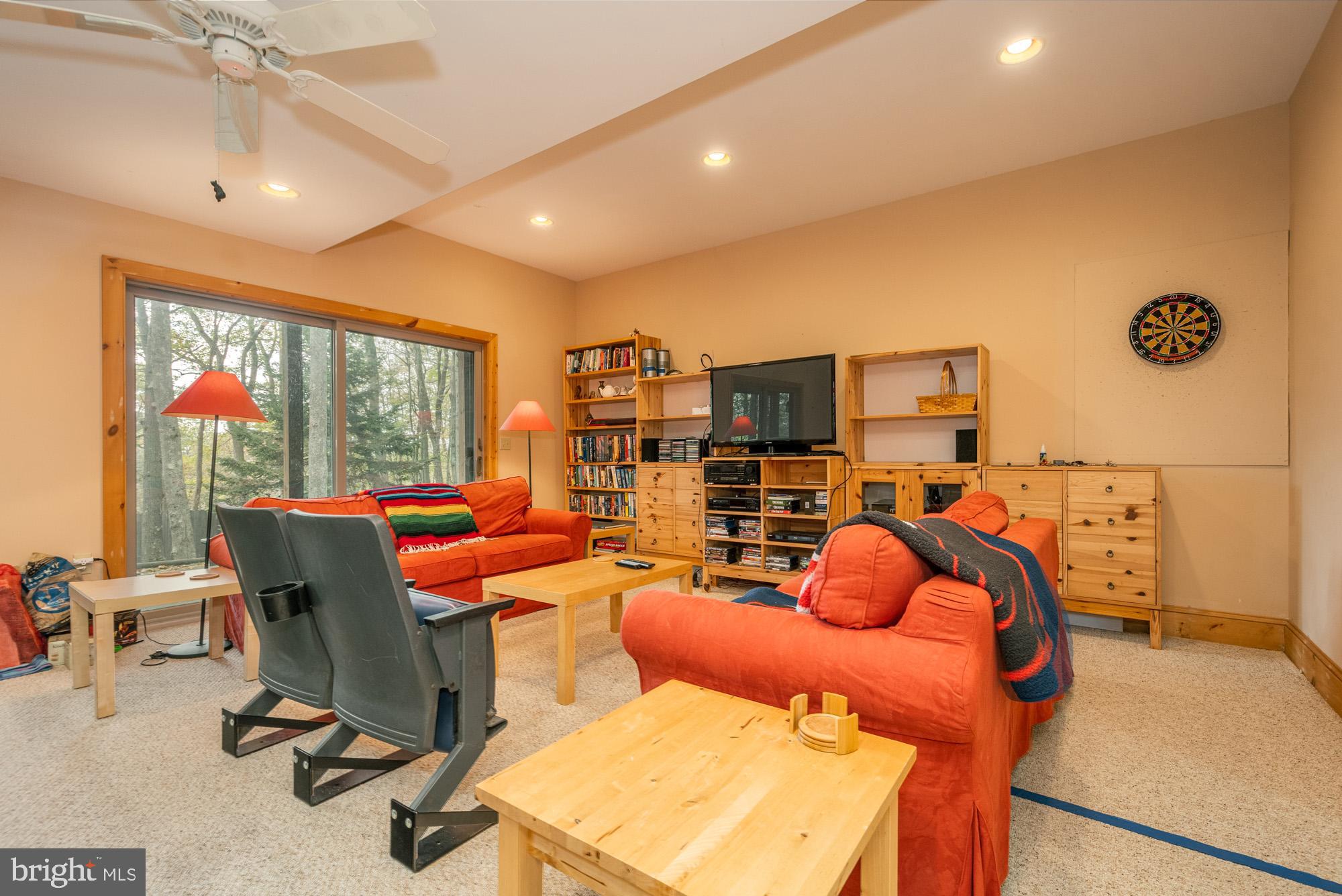 31 Linz Lane Swanton, MD 21561 - Photo 35 of 51 a living room with patio furniture and a floor to ceiling window