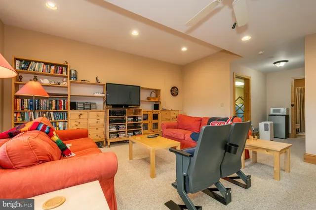 a room with pool table and windows