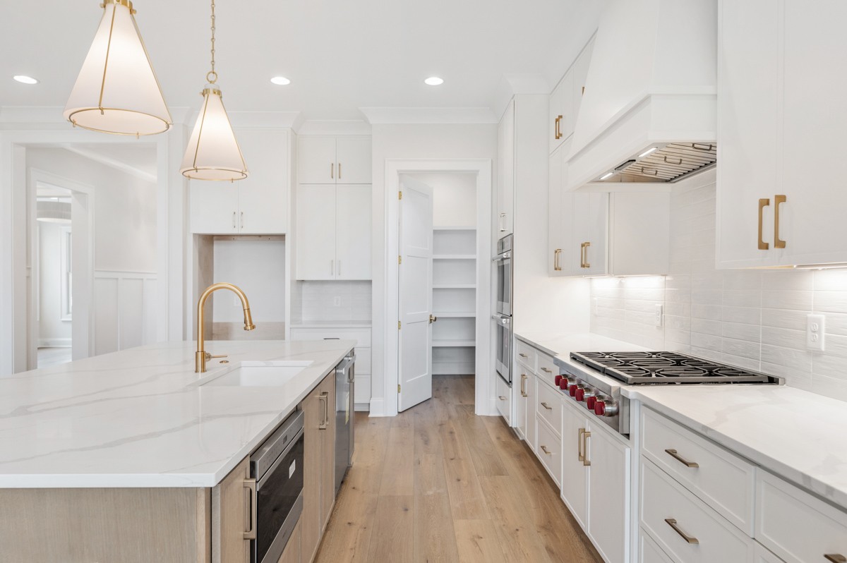 3151 Long Br Circle Franklin, TN 37064 - Photo 19 of 61 a kitchen with stainless steel appliances granite countertop a sink stove and cabinets