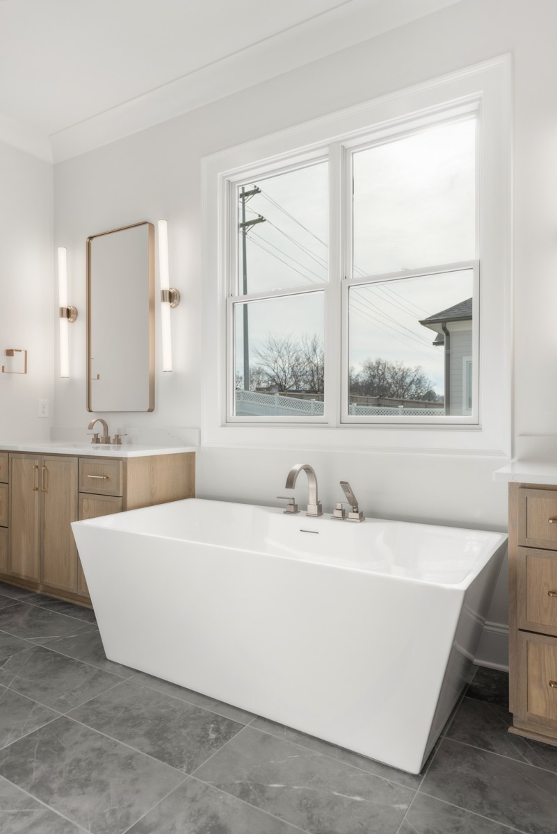 3151 Long Br Circle Franklin, TN 37064 - Photo 29 of 61 a bathroom with a bathtub a sink and a window