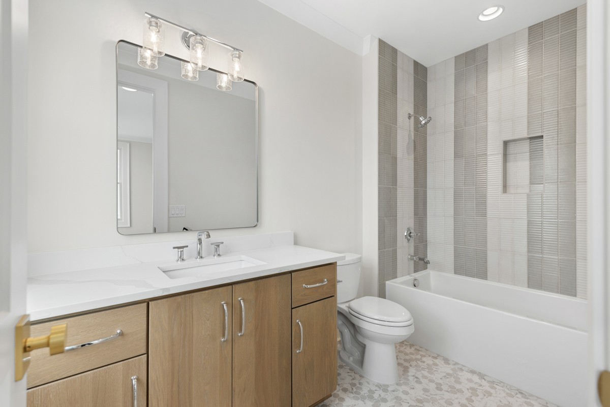 3151 Long Br Circle Franklin, TN 37064 - Photo 38 of 61 a bathroom with a granite countertop sink toilet a large mirror a bathtub and shower