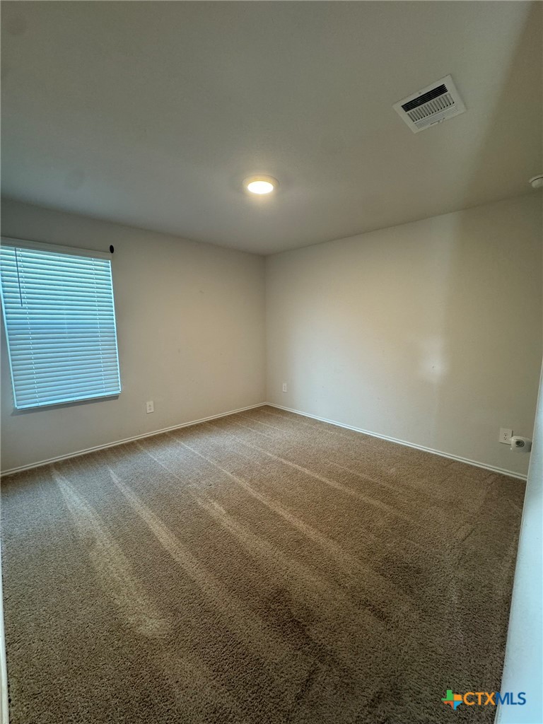 208 Ida Loop Seguin, TX 78155 - Photo 9 of 16 an empty room with a empty space and windows