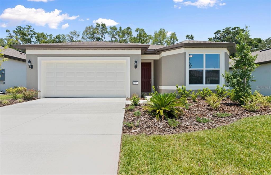 8215 Southwest 52nd Lane Road Ocala, FL 34481 - Photo 1 of 1 a front view of a house with garden