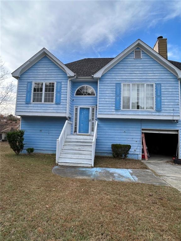 3658 Boulder Ridge Court Ellenwood, GA 30294 - Photo 1 of 4 a front view of a house with a yard