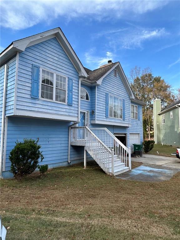 3658 Boulder Ridge Court Ellenwood, GA 30294 - Photo 3 of 4 a front view of a house with garden