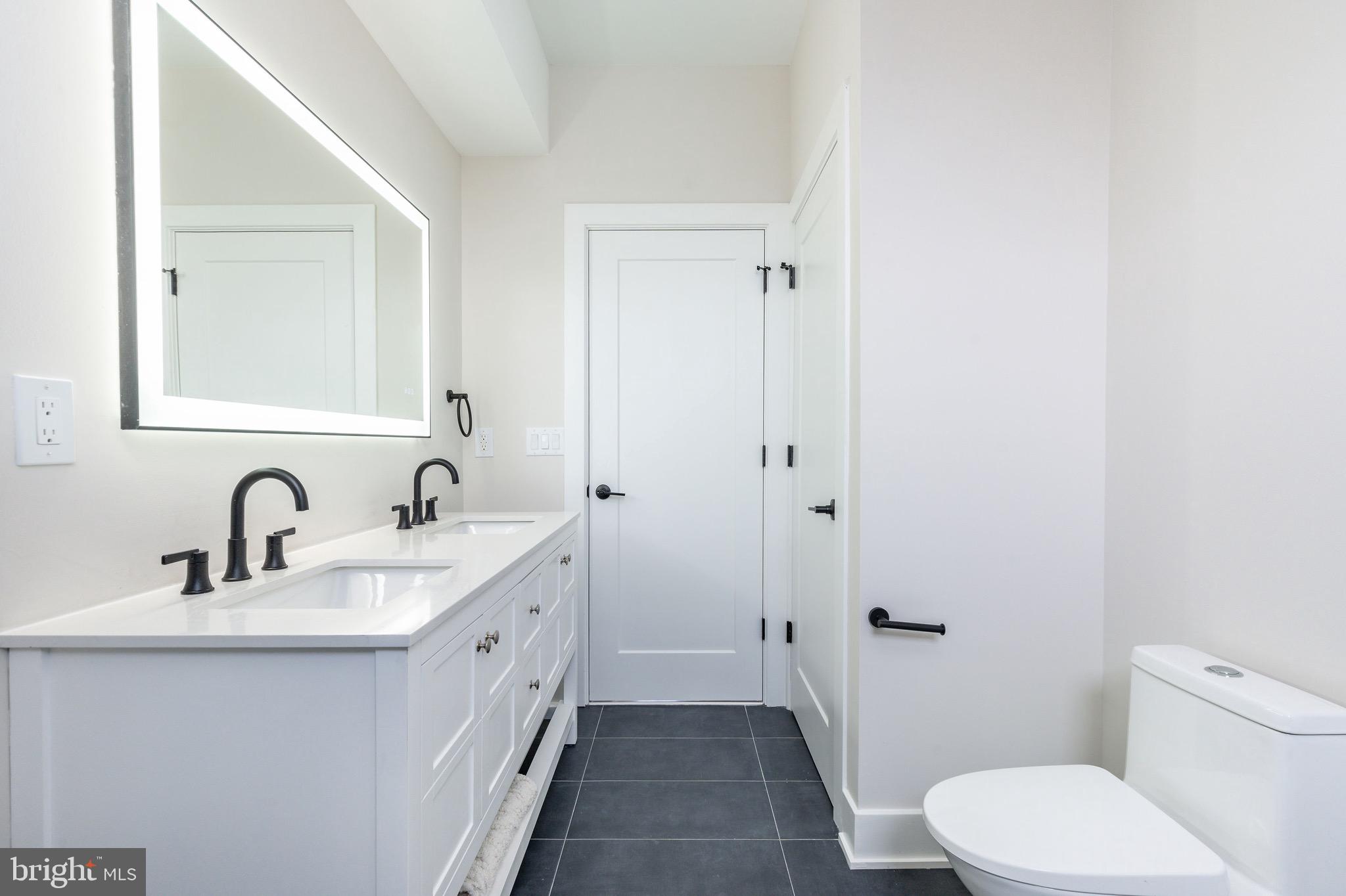 3841 Ridge Avenue Philadelphia, PA 19132 - Photo 17 of 45 a bathroom with a sink and mirror with toilet