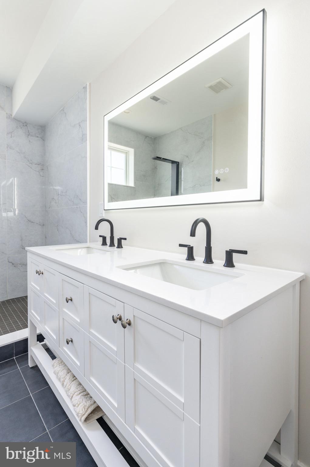 3841 Ridge Avenue Philadelphia, PA 19132 - Photo 19 of 45 a bathroom with a double vanity sink and a mirror