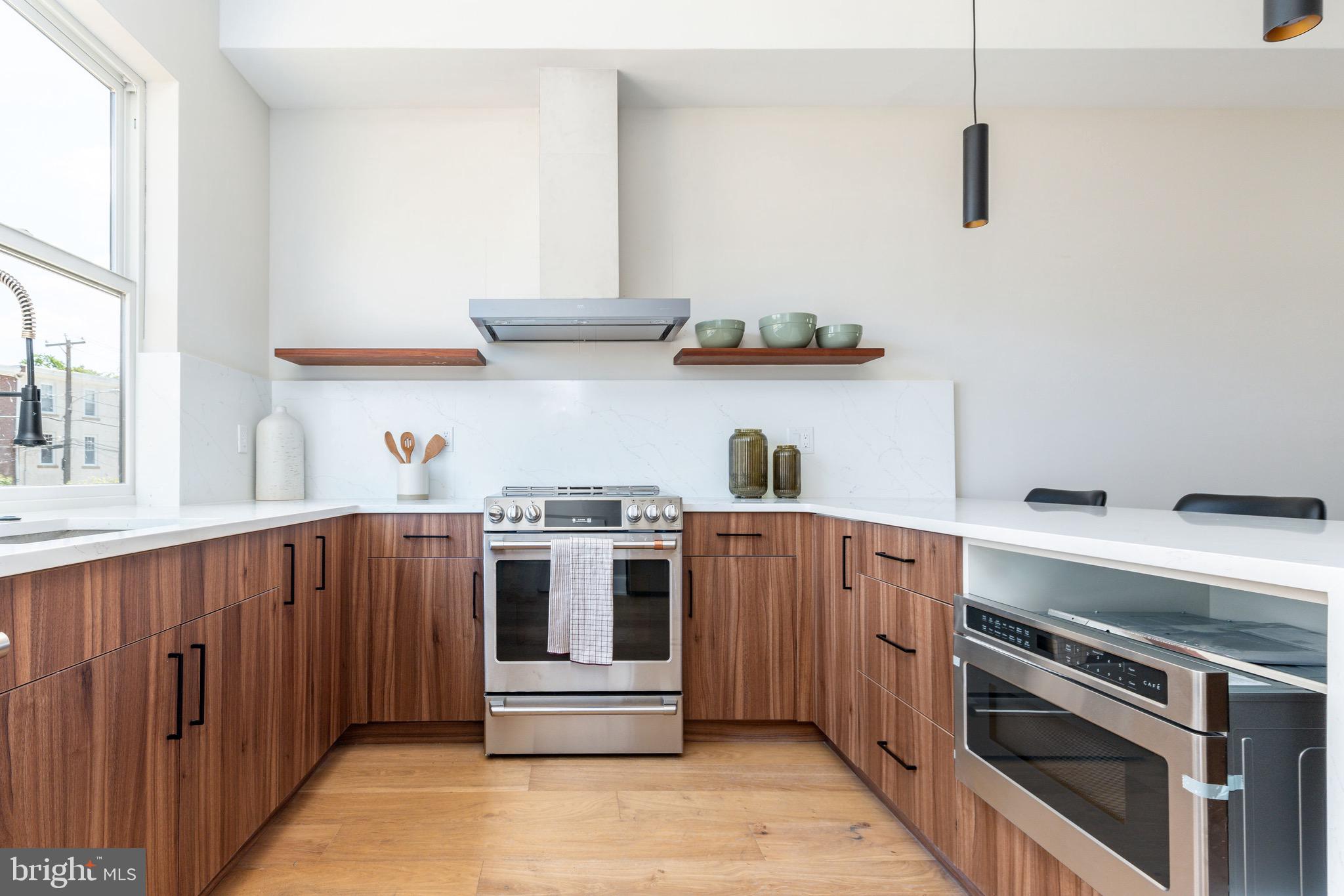 3841 Ridge Avenue Philadelphia, PA 19132 - Photo 2 of 45 a kitchen with stainless steel appliances a stove and wooden cabinets