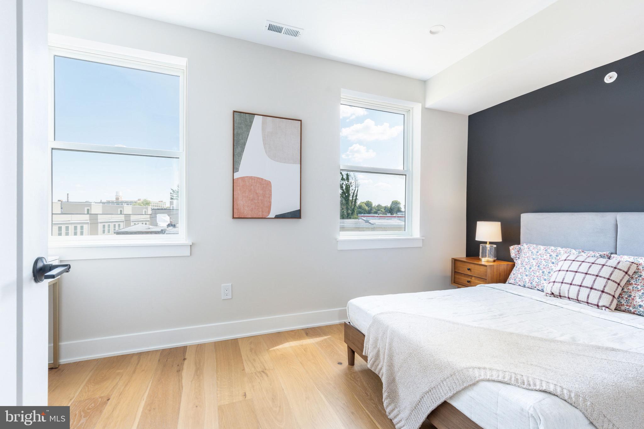 3841 Ridge Avenue Philadelphia, PA 19132 - Photo 29 of 45 a bedroom with a bed and wooden floor