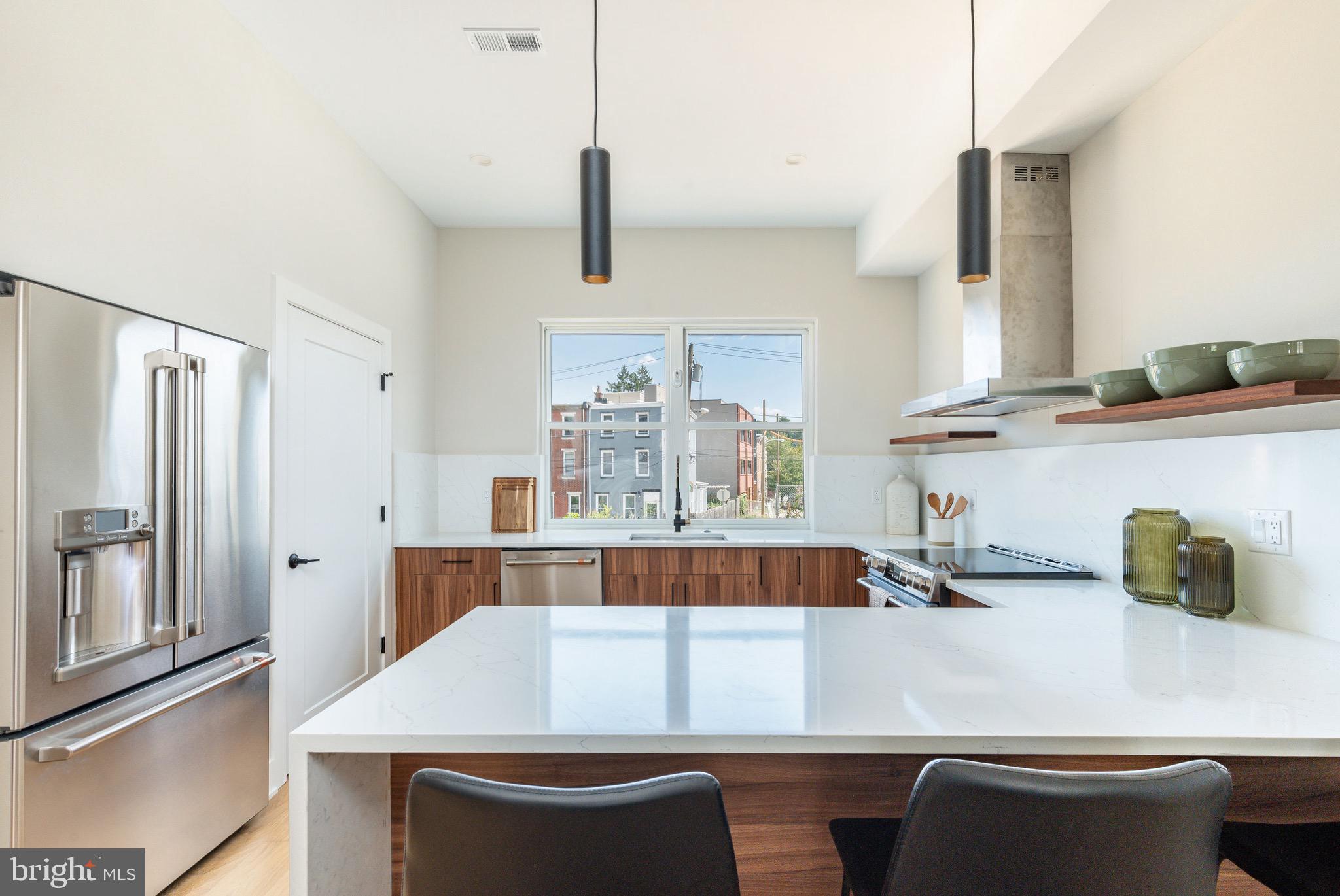 3841 Ridge Avenue Philadelphia, PA 19132 - Photo 3 of 45 a kitchen with a table chairs and cabinets