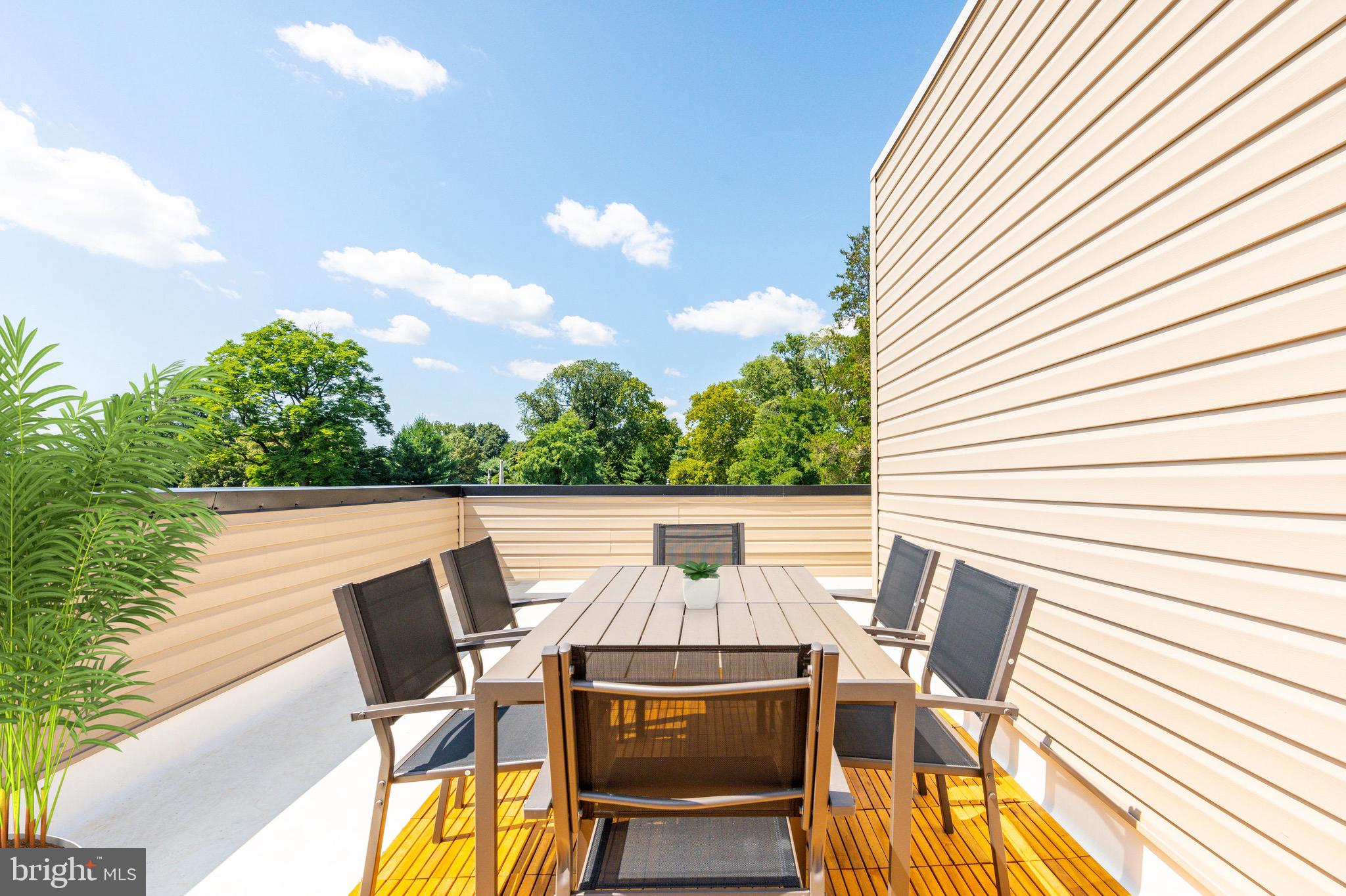 3841 Ridge Avenue Philadelphia, PA 19132 - Photo 35 of 45 a view of a patio with table and chairs and wooden floor