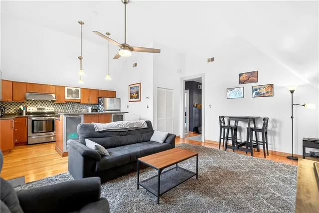 a kitchen with a refrigerator a sink and dishwasher with wooden floor