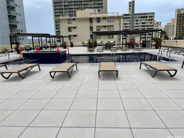 a outdoor space with lots of white furniture and a shower