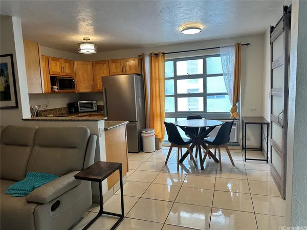 a view of a dining room with furniture and a window