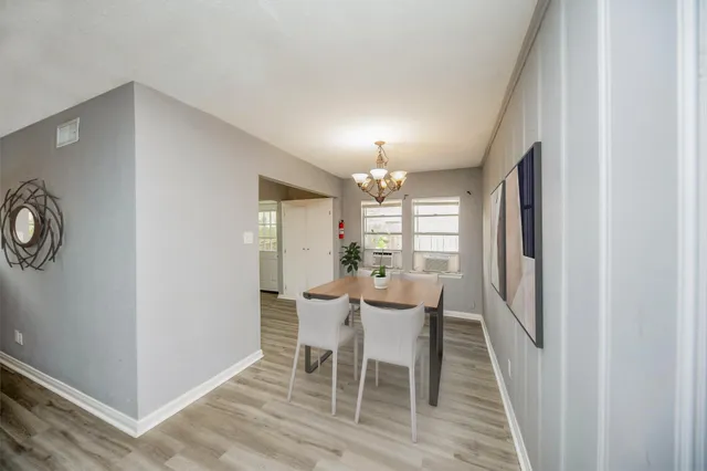 a view of a dining room with furniture and window