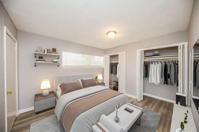 a bedroom with a bed and wooden floor