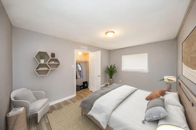 a bedroom with a bed and a window