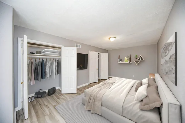 a bedroom with a large bed and a tv